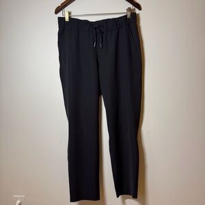 Lululemon On The Fly pants black elastic waist with drawstring and pockets.